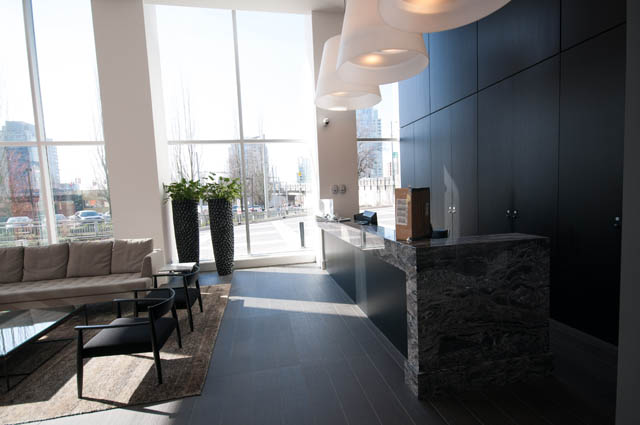 Furnished living room with large windows, city view, and modern decor. - 3301 - 1351 Continental Street, Vancouver Downtown