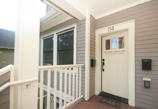 Furnished 2-bedroom townhouse porch with white railings and front door. - 114 West 14th Ave, Vancouver West Side
