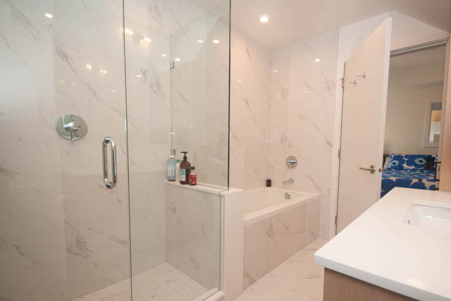 Bright bathroom with marble countertops and a walk-in shower. - 114 West 14th Ave, Vancouver West Side