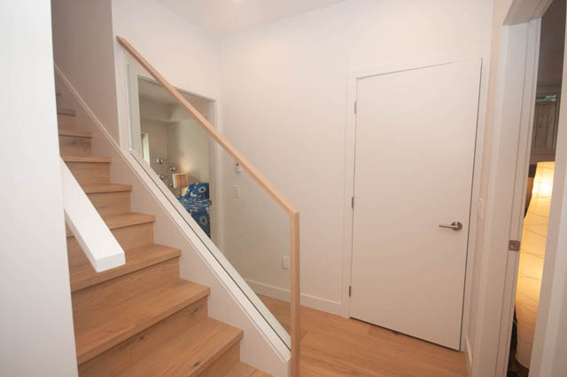 Staircase leading to upper level with wooden steps and white walls. - 114 West 14th Ave, Vancouver West Side