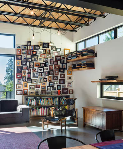 Bright living room with wall of framed photos and bookshelves, modern decor. - Address WITHHELD, North Vancouver