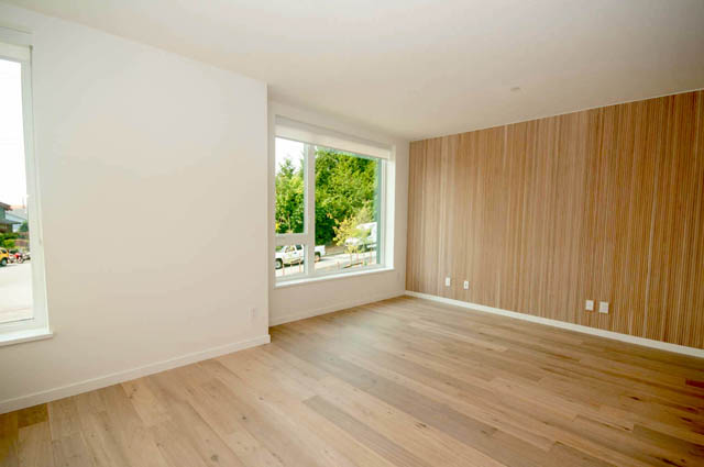 Spacious living room with hardwood floors and large windows. - 9 - 528 East 2nd, North Vancouver