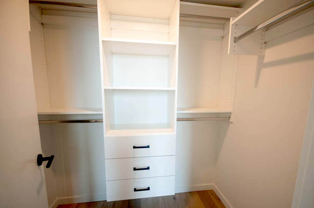 Spacious walk-in closet with built-in shelves and drawers, perfect for storage. - 9 - 528 East 2nd, North Vancouver