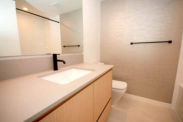 Modern bathroom with sleek countertop and minimalist design. - 9 - 528 East 2nd, North Vancouver
