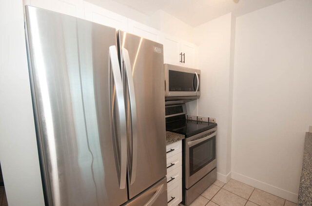 Bright kitchen with stainless steel appliances and granite countertops. - 1907 - 1420 West Georgia Street, Vancouver Downtown