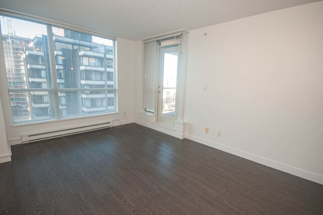 Spacious living room with hardwood floors, large windows, and city view. - 1907 - 1420 West Georgia Street, Vancouver Downtown