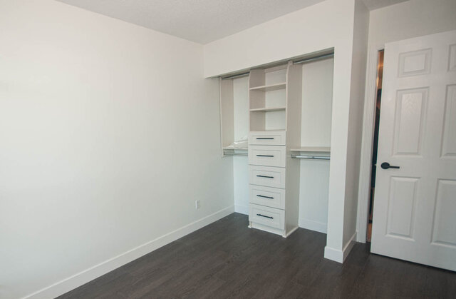 Spacious den with built-in shelving and drawers, hardwood floors, and a sliding door. - 1907 - 1420 West Georgia Street, Vancouver Downtown