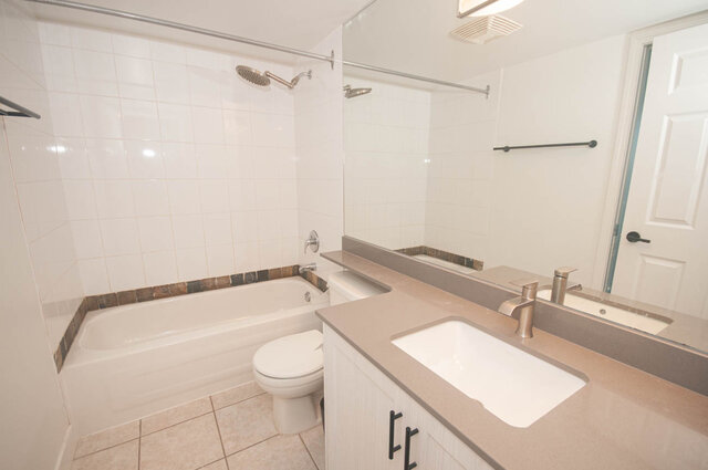 Spacious bathroom with dual sinks, modern vanity, and a large shower. - 1907 - 1420 West Georgia Street, Vancouver Downtown