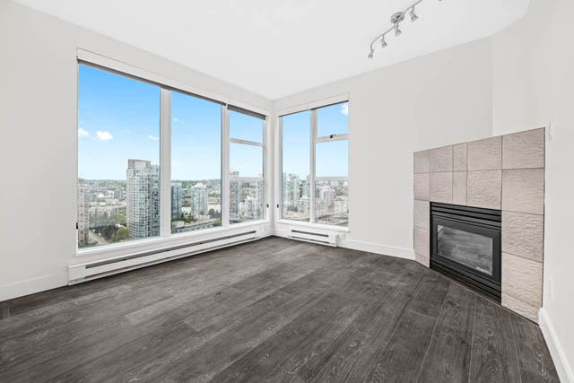 Spacious living room with hardwood floors, large windows, and a city view. - 2607 - 939 Homer St, Vancouver Downtown