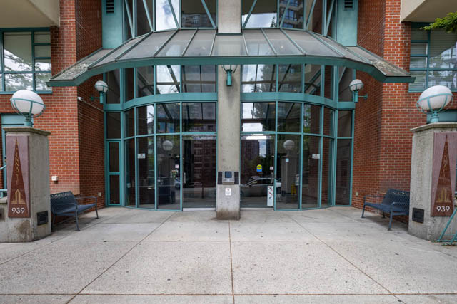 Furnished 2-bedroom condo with large glass entrance, brick facade, and modern lighting. - 2607 - 939 Homer St, Vancouver Downtown