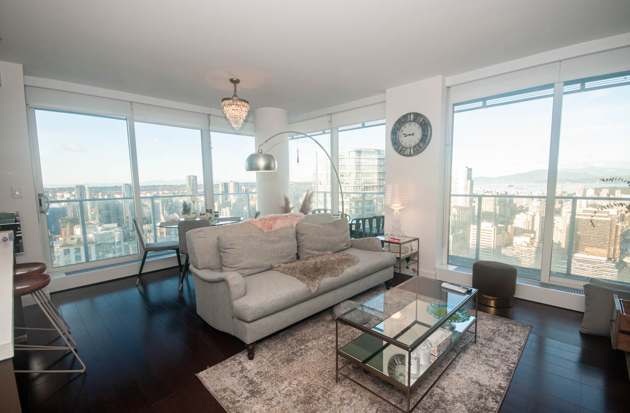 Bright living room with city view, modern furnishings, and hardwood floors. - 4502 - 777 Richards St, Vancouver Downtown