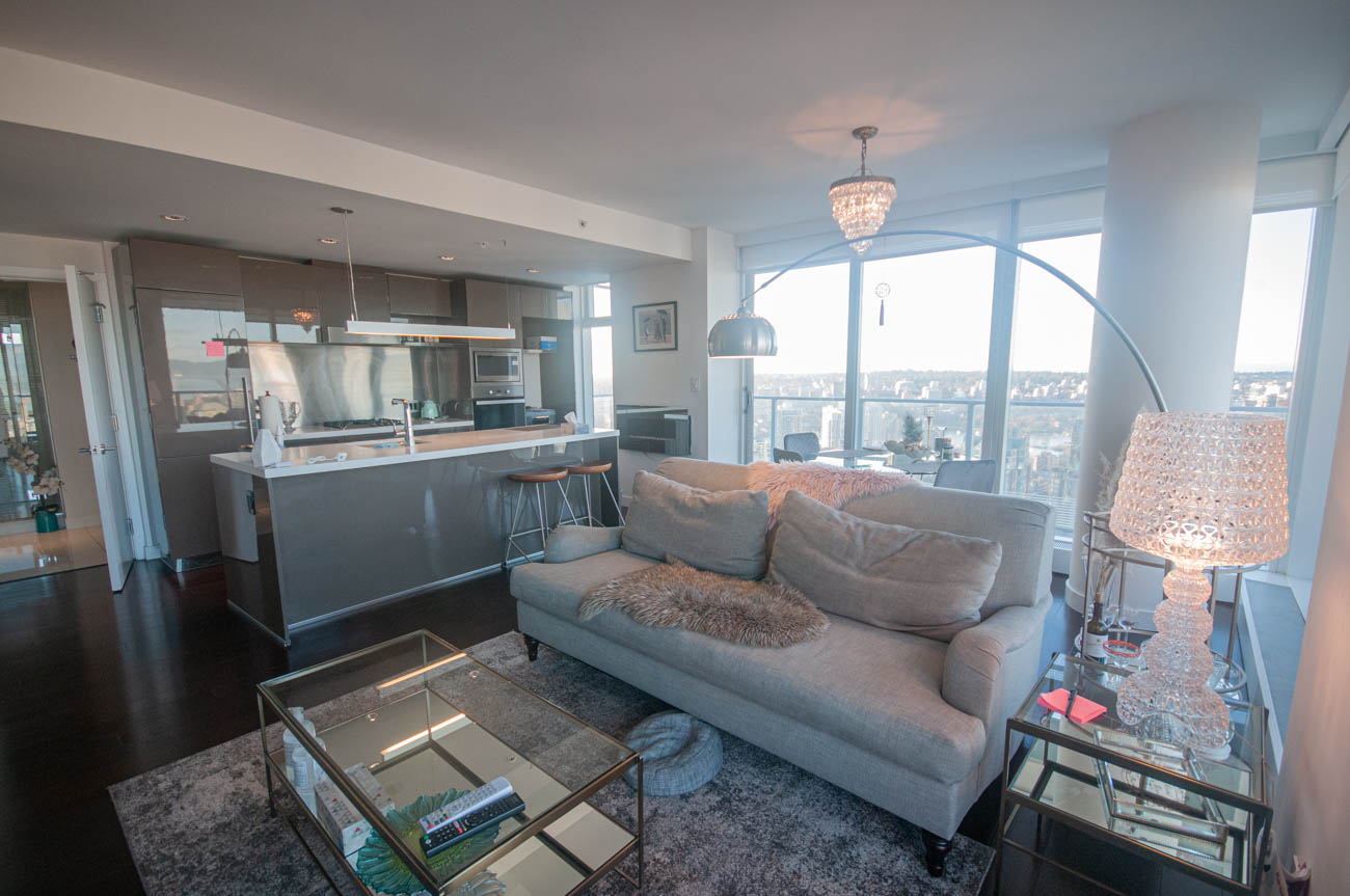 Bright living room with city view, modern furnishings, and hardwood floors. - 4502 - 777 Richards St, Vancouver Downtown
