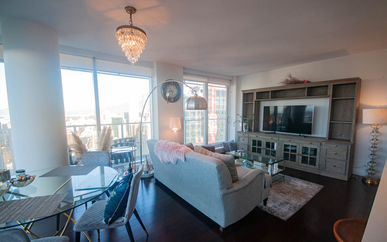 Furnished living room with city view, modern furniture, and hardwood floors. - 4502 - 777 Richards St, Vancouver Downtown