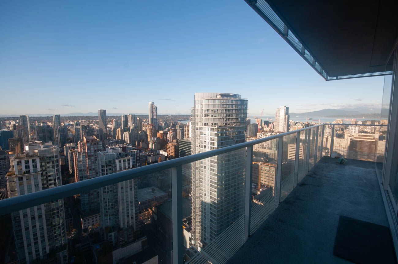 Furnished balcony with stunning city view and modern architecture. - 4502 - 777 Richards St, Vancouver Downtown