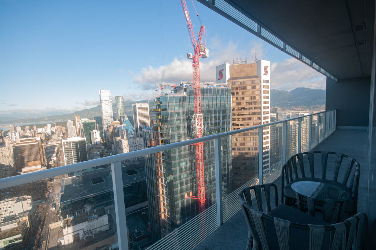 Furnished balcony with city view and construction crane. - 4502 - 777 Richards St, Vancouver Downtown