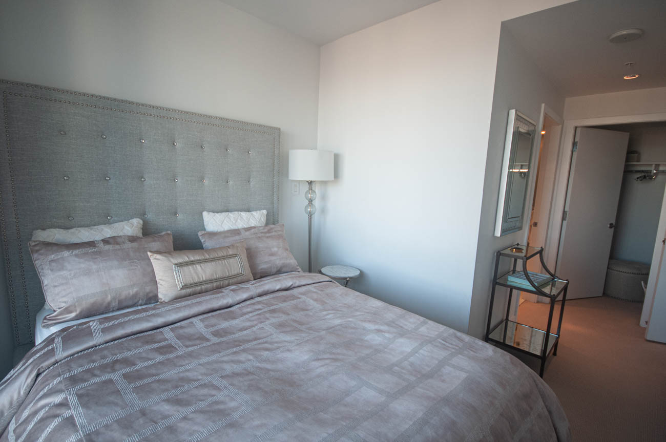 Furnished bedroom with tufted headboard and modern decor. - 4502 - 777 Richards St, Vancouver Downtown