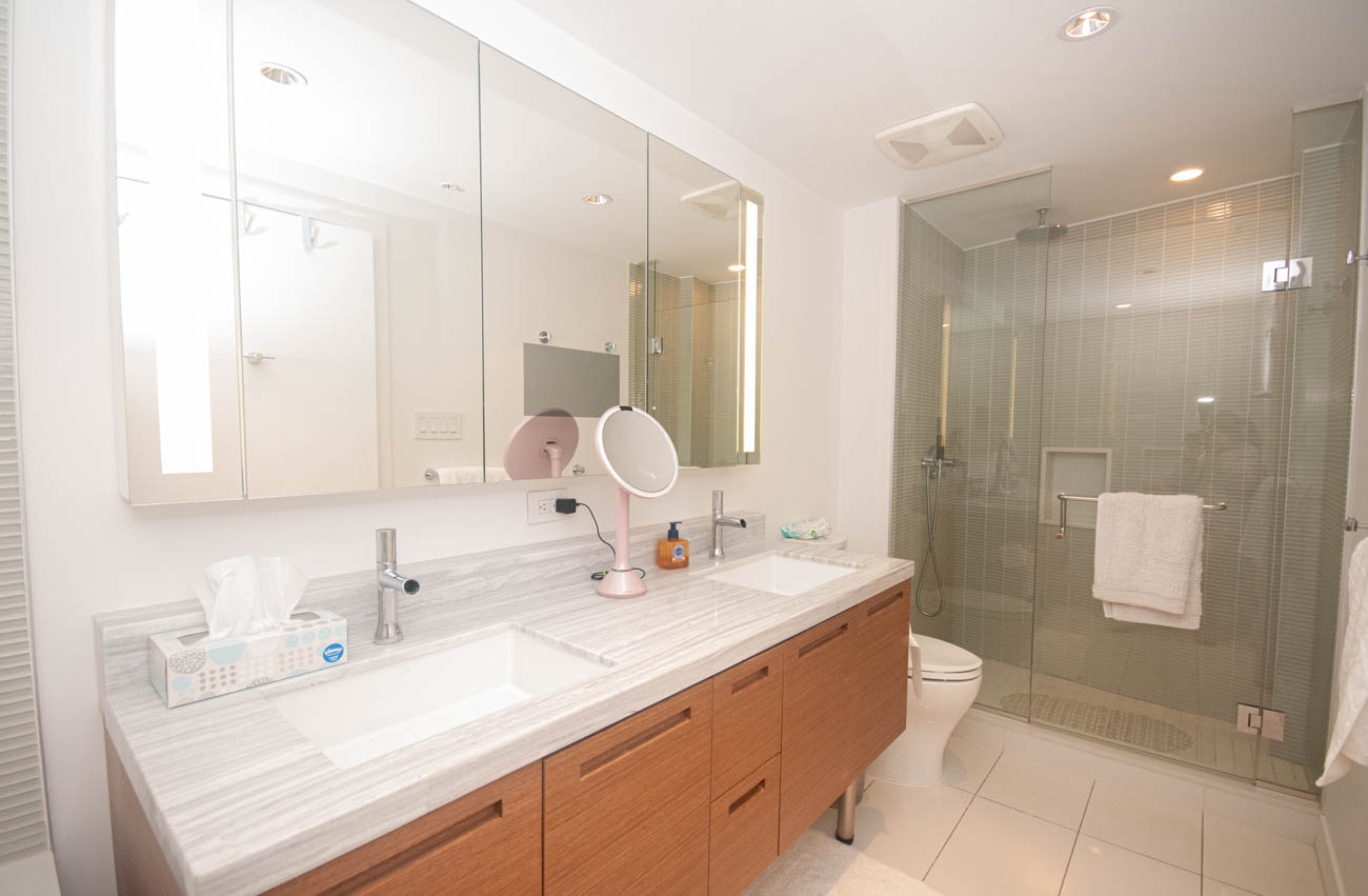 Furnished bathroom with marble countertops and a glass-enclosed shower. - 4502 - 777 Richards St, Vancouver Downtown