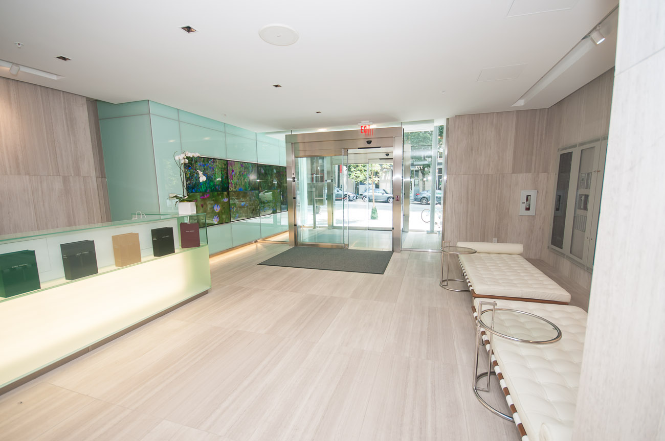 Furnished living room with modern furniture and glass display case. - 4502 - 777 Richards St, Vancouver Downtown