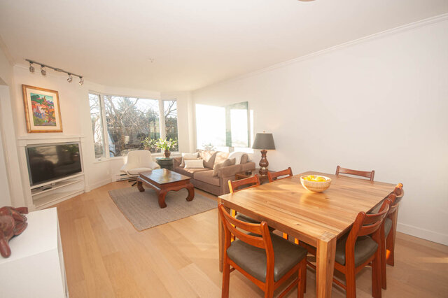 Spacious living room with hardwood floors, large windows, and a cozy sofa. - 308 - 1688 Cypress Street, Vancouver West Side