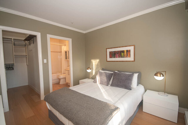 Spacious bedroom with hardwood floors, modern lighting, and a cozy bed setup. - 308 - 1688 Cypress Street, Vancouver West Side