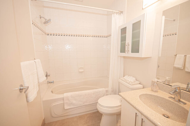 Spacious bathroom with granite countertops and a bathtub/shower combo. - 308 - 1688 Cypress Street, Vancouver West Side