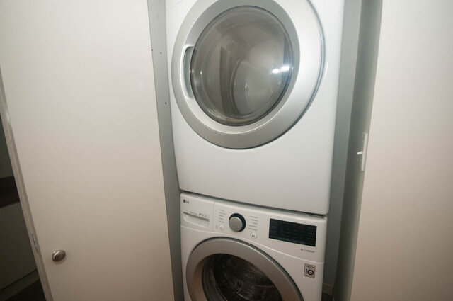 Bright laundry room with modern LG washer and dryer, clean white surfaces, and a compact design. - 308 - 1688 Cypress Street, Vancouver West Side