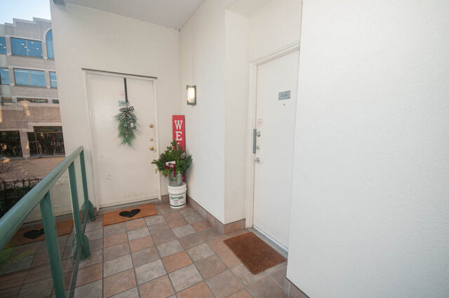 Furnished entryway with a festive wreath and "Welcome" sign, leading to a cozy 2-bedroom condo. - 308 - 1688 Cypress Street, Vancouver West Side