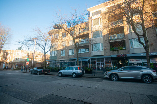 Spacious 2-bedroom condo with modern furnishings and large windows offering a cozy, urban living space.