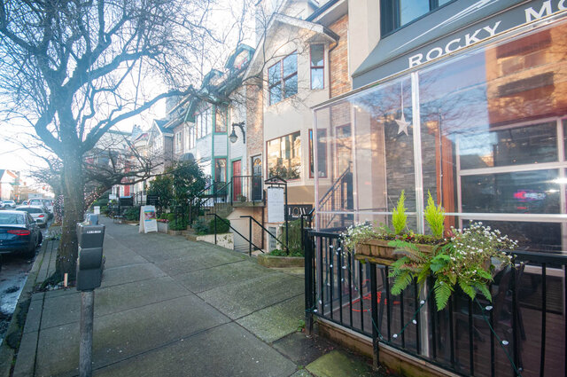 Spacious living room with large windows, cozy plants, and a view of the street. - 308 - 1688 Cypress Street, Vancouver West Side