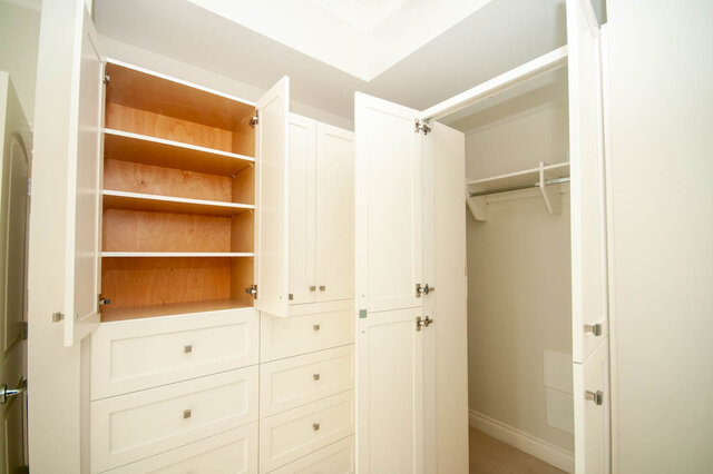 Spacious walk-in closet with built-in shelves and a sliding door. - 912 - 175 Victory Ship Way, North Vancouver