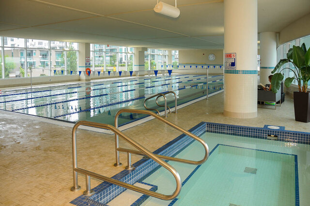 Spacious indoor pool with tiled floors and city views. - 912 - 175 Victory Ship Way, North Vancouver