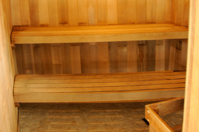 Spacious, well-lit sauna with wooden benches and tiled floor. - 912 - 175 Victory Ship Way, North Vancouver