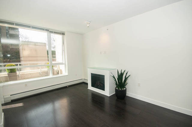 Spacious living room with hardwood floors and city view. - 103 - 175 West 2nd, North Vancouver