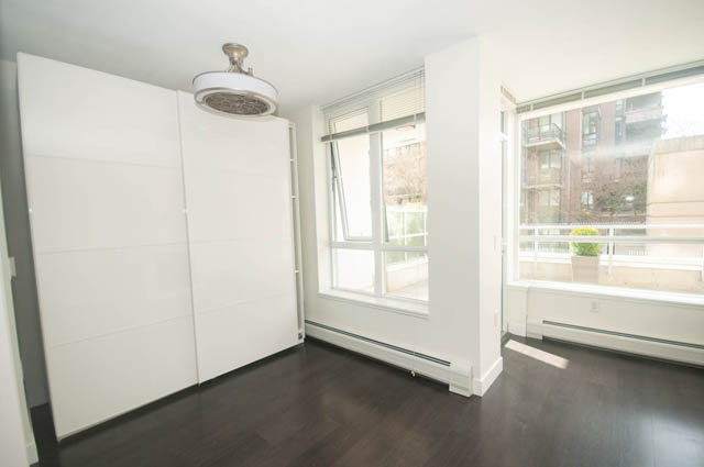 Bright living room with hardwood floors and city view. - 103 - 175 West 2nd, North Vancouver
