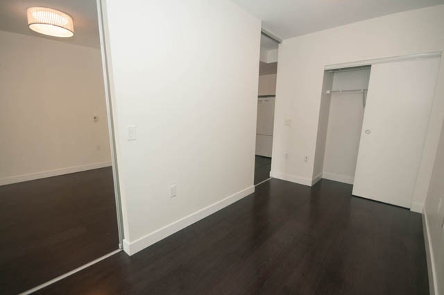 Bright living room with hardwood floors and a closet. - 103 - 175 West 2nd, North Vancouver