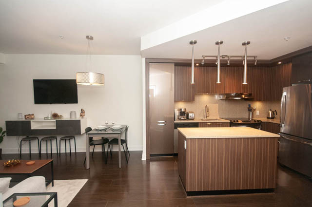 Furnished 1-bedroom + den with modern kitchen, hardwood floors, and a cozy living area. - 211 - 733 West 14th, North Vancouver