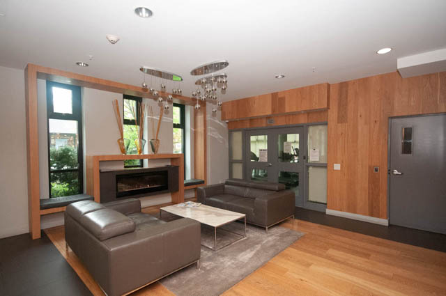 Furnished living room with hardwood floors, city view, and modern decor. - 211 - 733 West 14th, North Vancouver