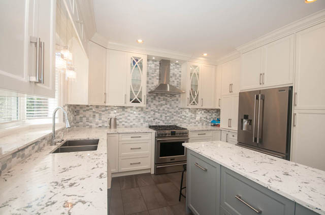 Bright kitchen with white cabinets, marble countertops, and stainless steel appliances. - Upper  - 2318 West 14th Ave, Vancouver West Side