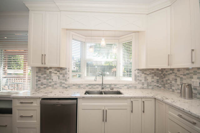 Bright kitchen with white cabinets, marble countertops, and a bay window. - Upper  - 2318 West 14th Ave, Vancouver West Side