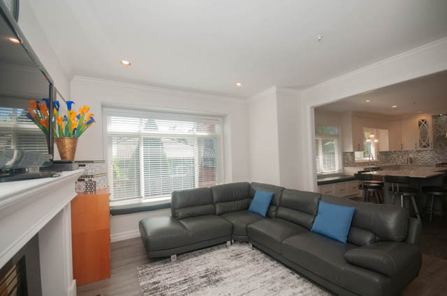 Spacious living room with modern furniture, large windows, and a sleek countertop. - Upper  - 2318 West 14th Ave, Vancouver West Side