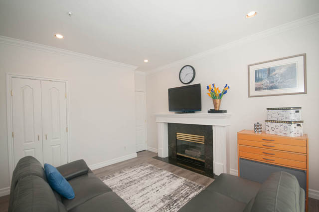 Bright living room with hardwood floors, modern furniture, and a city view. - Upper  - 2318 West 14th Ave, Vancouver West Side