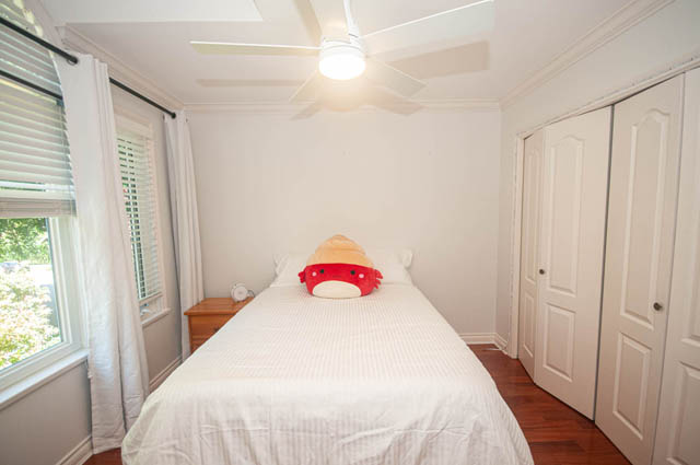 Bright bedroom with white walls, wooden floors, and a ceiling fan. - Upper  - 2318 West 14th Ave, Vancouver West Side