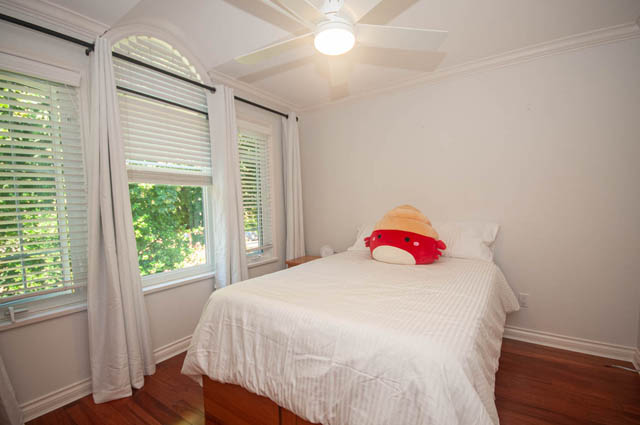 Bright bedroom with wooden floors, white walls, and a ceiling fan. - Upper  - 2318 West 14th Ave, Vancouver West Side