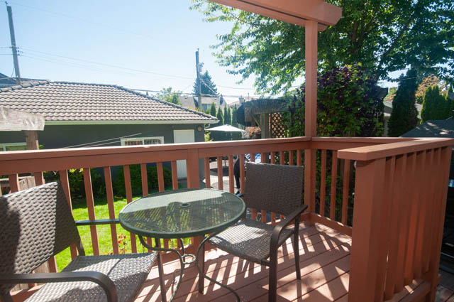 Furnished patio with wooden railings, outdoor furniture, and greenery. - Upper  - 2318 West 14th Ave, Vancouver West Side