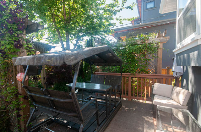 Furnished patio with wooden furniture and a gazebo, surrounded by greenery. - Upper  - 2318 West 14th Ave, Vancouver West Side