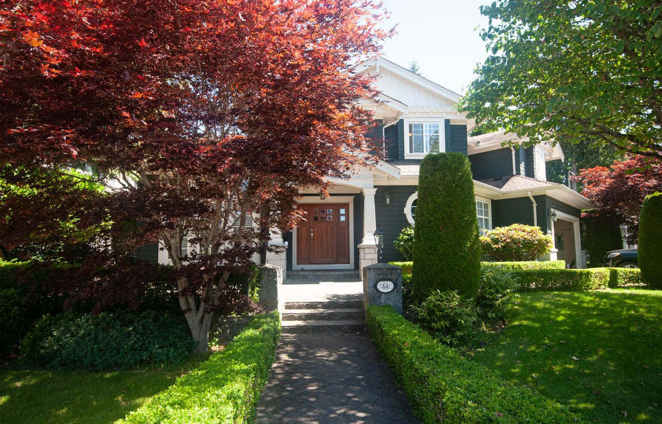 Furnished 5-bedroom + den house with a well-maintained front garden and a red-leaved tree. - 3440 Wellington Crescent, North Vancouver