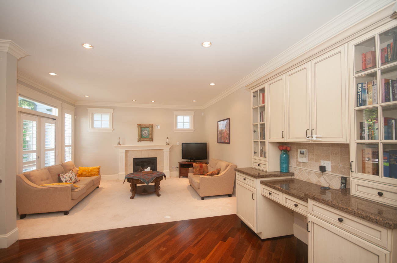 Bright living room with hardwood floors, granite countertops, and built-in cabinets. - 3440 Wellington Crescent, North Vancouver