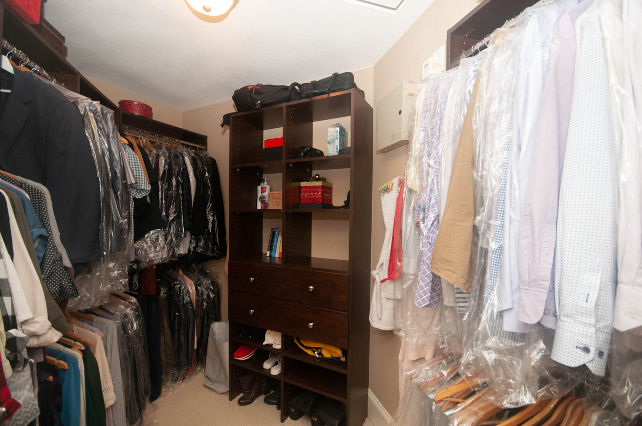 Spacious walk-in closet with hanging clothes and shelves, organized and tidy. - 3440 Wellington Crescent, North Vancouver