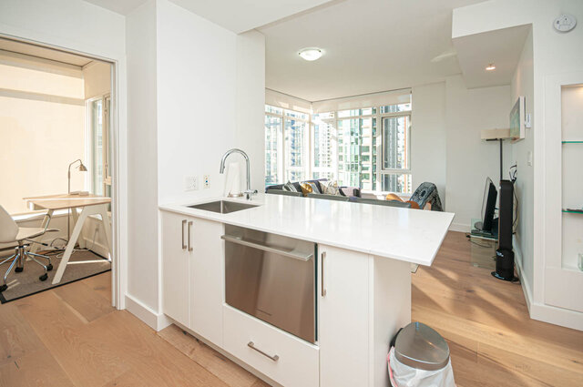 kitchen with white cabinets, stainless steel dishwasher, sink with faucet, and hardwood floors - 1306-480 Robson Street, Vancouver Downtown