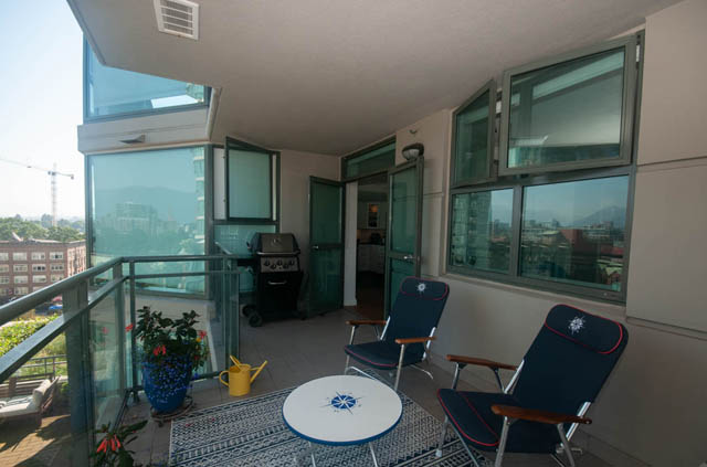 Spacious balcony with a city view, outdoor seating, and a barbecue grill. - 801-1128 Quebec st, Vancouver Downtown